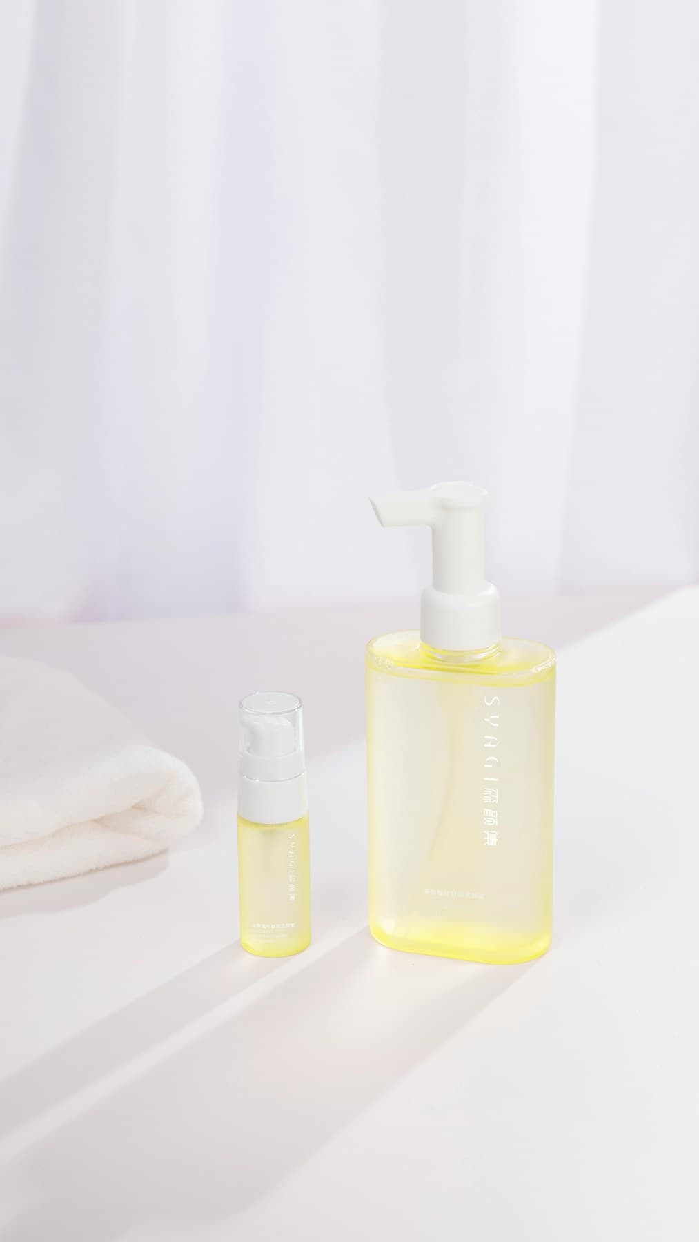 Cleansing oil bottles illuminated on soft white set