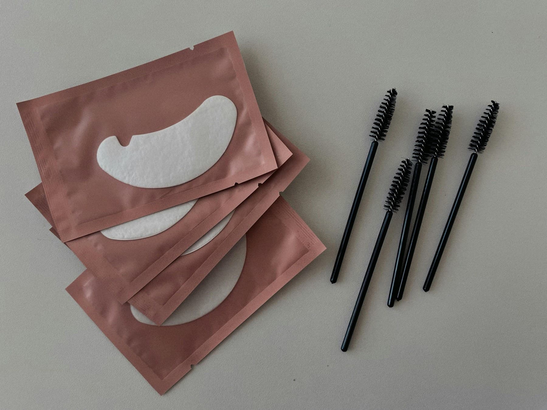 Minimal eye-care and lash styling edit in soft neutral tones