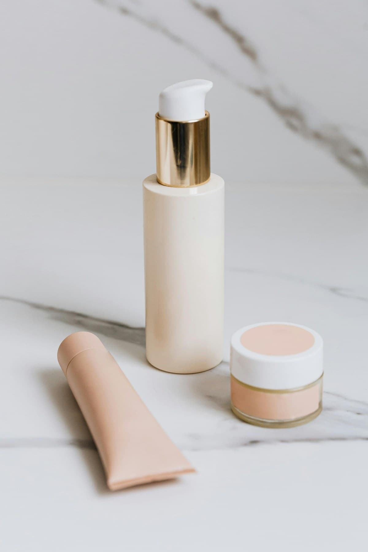 Refined complexion essentials arranged on pale marble